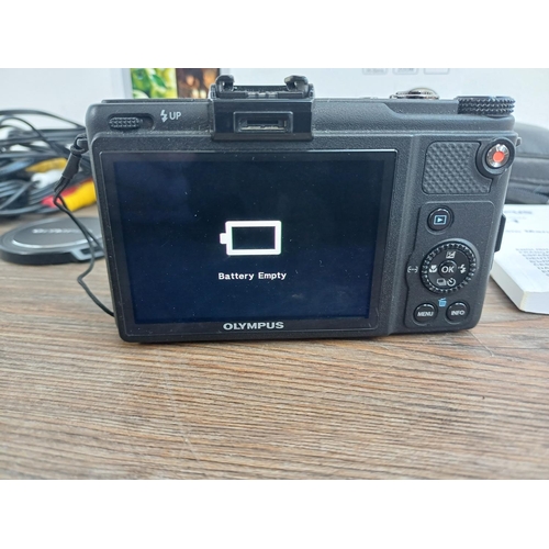 694 - A boxed and cased Olympus XZ-1 10mp CCD sensor compact digital camera with cables and instruction ma... 