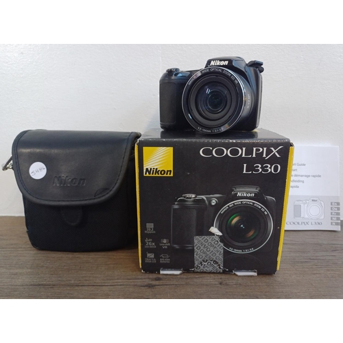 697 - A boxed and cased Nikon Coolpix L330 20.2mp CCD sensor compact digital bridge camera with instructio... 