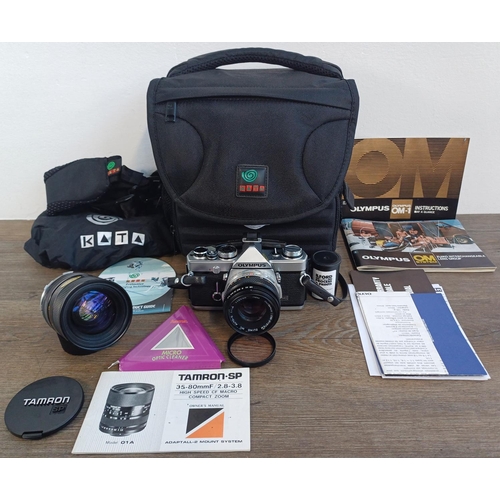 704 - A Kata camera bag containing Olympus OM-1N MD 35mm SLR camera fitted with Zuiko MC Auto-S 1:1.8 50mm... 