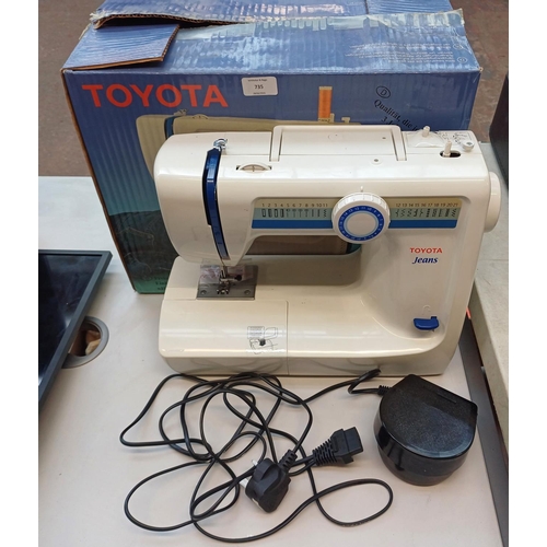 735 - A boxed Toyota Jeans 21 stitch programme electric sewing machine with foot pedal