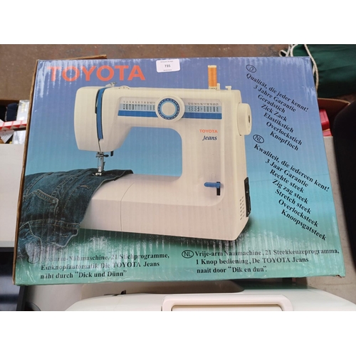 735 - A boxed Toyota Jeans 21 stitch programme electric sewing machine with foot pedal