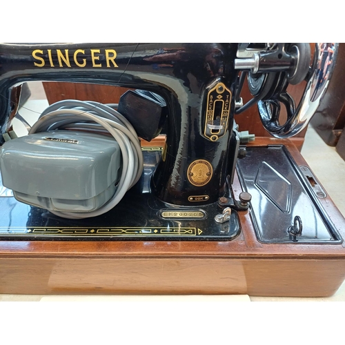 737 - A cased 1955 Singer 99K electric sewing machine with foot pedal, fitted light, accessories and key