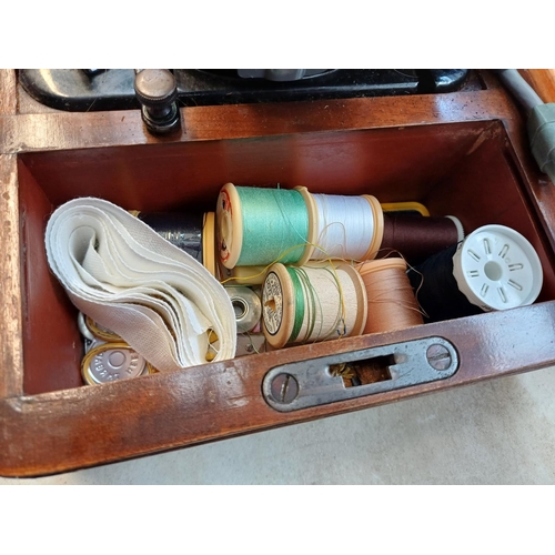 737 - A cased 1955 Singer 99K electric sewing machine with foot pedal, fitted light, accessories and key