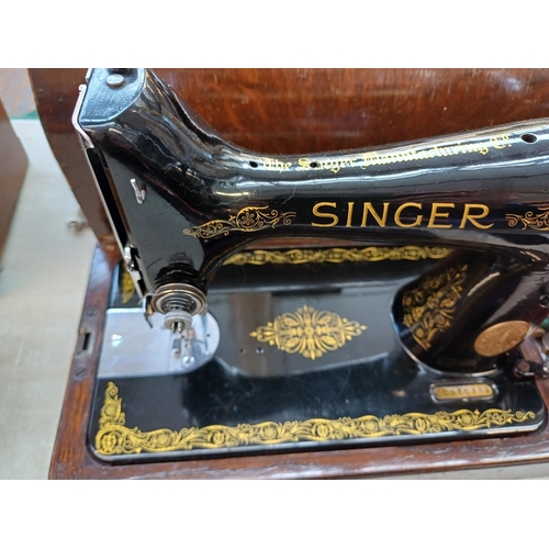 738 - A cased 1939 Singer 99K hand crank sewing machine with boxed attachments, accessories and key