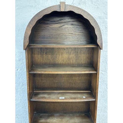 103 - An oak arched top seven tier bookcase - approx. 172cm high x 54cm wide x 18cm deep