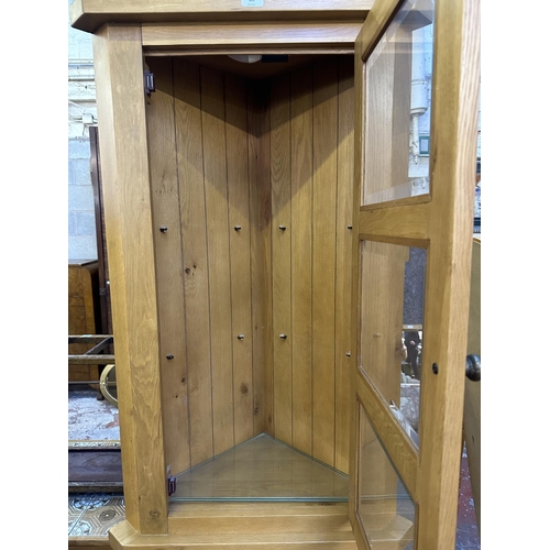 105 - A Morris Furniture Company oak free standing corner display cabinet - approx. 195cm high x 70cm wide... 