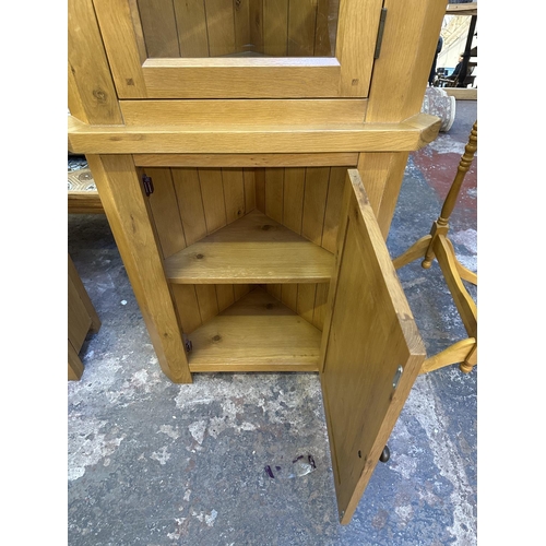 105 - A Morris Furniture Company oak free standing corner display cabinet - approx. 195cm high x 70cm wide... 