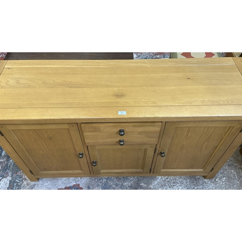 109 - A Morris Furniture Company oak sideboard - approx. 85cm high x 150cm wide x 45cm deep