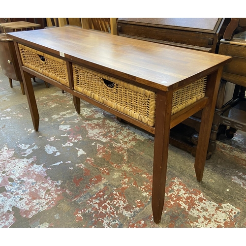 129 - A modern hardwood and wicker two drawer console table - approx. 71cm high x 125cm wide x 45cm deep