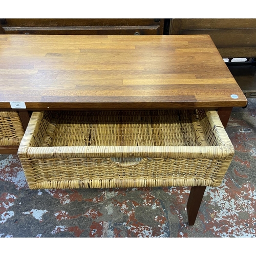 129 - A modern hardwood and wicker two drawer console table - approx. 71cm high x 125cm wide x 45cm deep