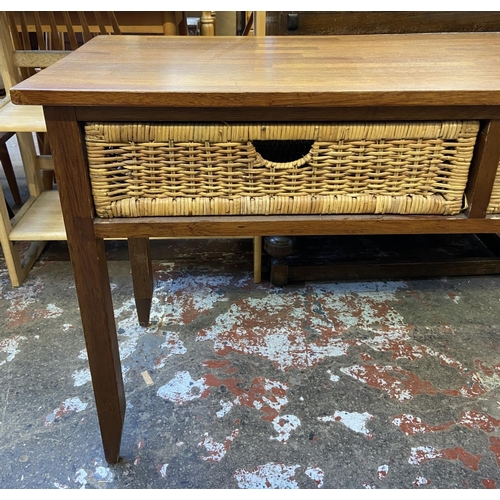 129 - A modern hardwood and wicker two drawer console table - approx. 71cm high x 125cm wide x 45cm deep