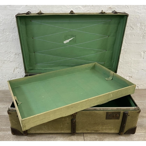 138 - An early/mid 20th century wooden banded green canvas and brown leather travel trunk, patent no. 2316... 