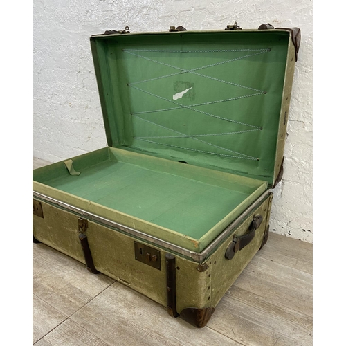 138 - An early/mid 20th century wooden banded green canvas and brown leather travel trunk, patent no. 2316... 