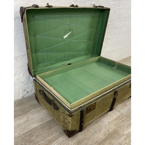 138 - An early/mid 20th century wooden banded green canvas and brown leather travel trunk, patent no. 2316... 