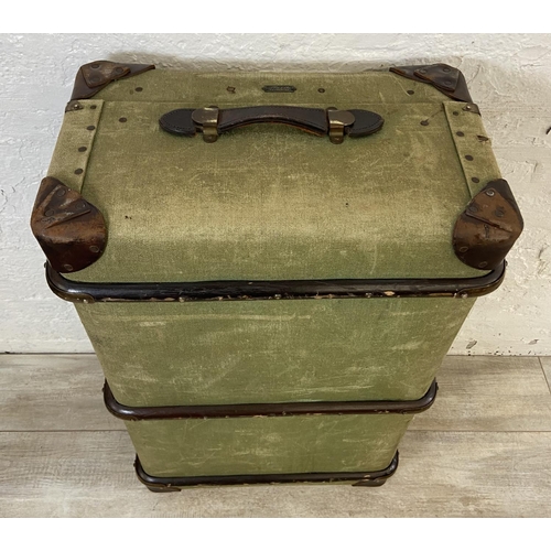 138 - An early/mid 20th century wooden banded green canvas and brown leather travel trunk, patent no. 2316... 