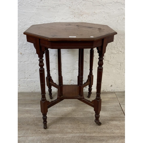 148 - A Victorian walnut octagonal two tier side table - approx. 70cm high x 59cm wide x 59cm deep