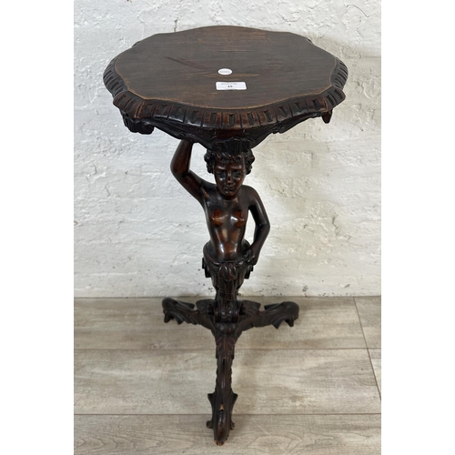 15 - A 19th century carved walnut tripod pedestal jardinière stand with putti design - approx. 95cm high