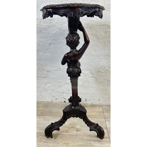 15 - A 19th century carved walnut tripod pedestal jardinière stand with putti design - approx. 95cm high