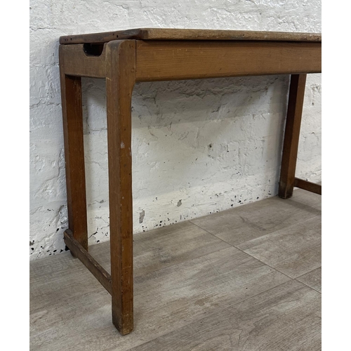 168 - A mid 20th century beech child's school desk and two chairs - approx. 57cm high x 98cm wide x 37cm d... 