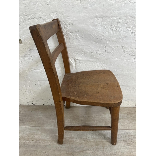 168 - A mid 20th century beech child's school desk and two chairs - approx. 57cm high x 98cm wide x 37cm d... 