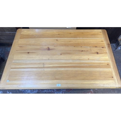 169 - A pine dining table - approx. 74cm high x 76cm wide x 121cm long