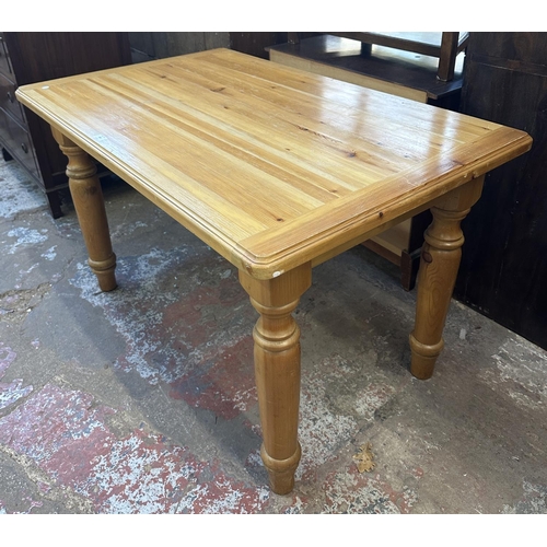 169 - A pine dining table - approx. 74cm high x 76cm wide x 121cm long