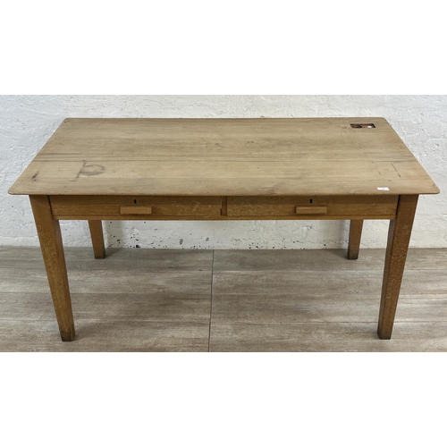 176 - A mid 20th century beech two drawer school desk - approx. 77cm high x 153cm wide x 77cm deep