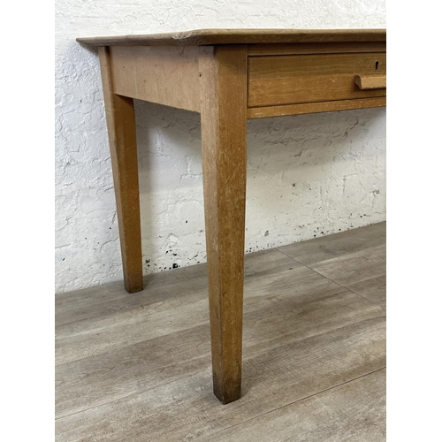 176 - A mid 20th century beech two drawer school desk - approx. 77cm high x 153cm wide x 77cm deep