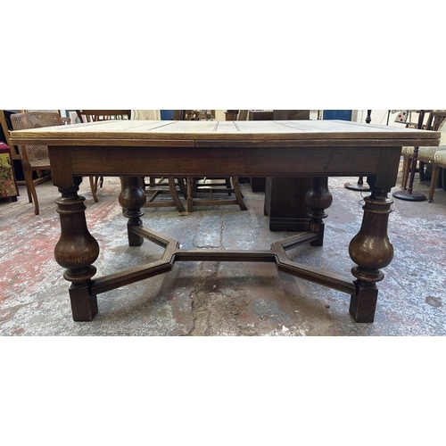 179 - A 1930s oak draw leaf dining table - approx. 78cm high x 100cm wide x 140cm long