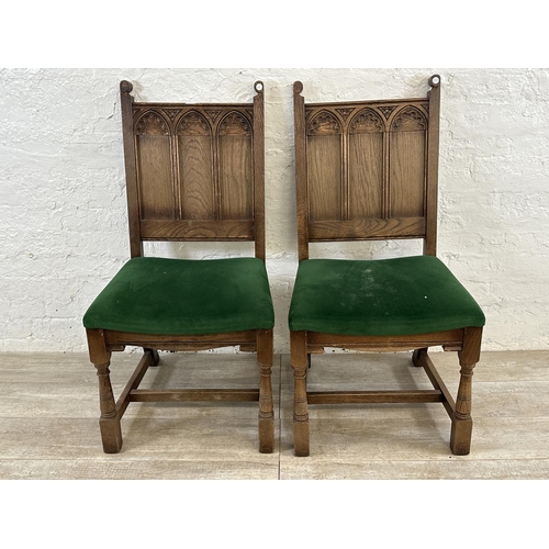 181 - A pair of 17th century style carved oak and green fabric upholstered dining chairs