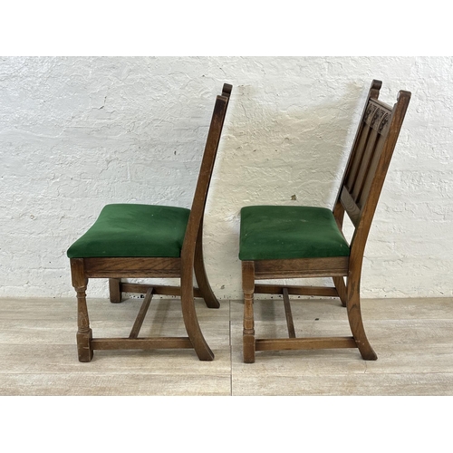 181 - A pair of 17th century style carved oak and green fabric upholstered dining chairs