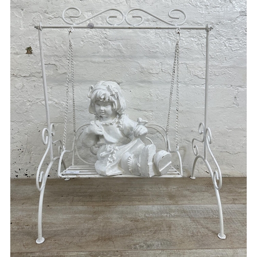 183 - A white painted wrought metal fibreglass child and swing garden ornament - approx. 65cm high x 51cm ... 