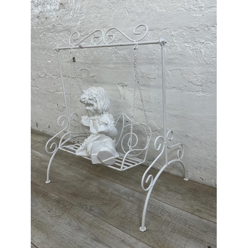 183 - A white painted wrought metal fibreglass child and swing garden ornament - approx. 65cm high x 51cm ... 