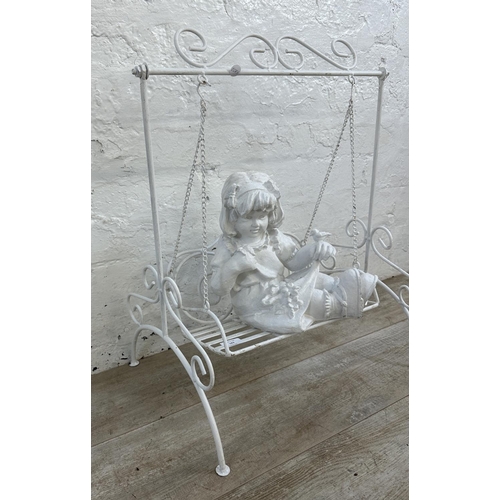 183 - A white painted wrought metal fibreglass child and swing garden ornament - approx. 65cm high x 51cm ... 