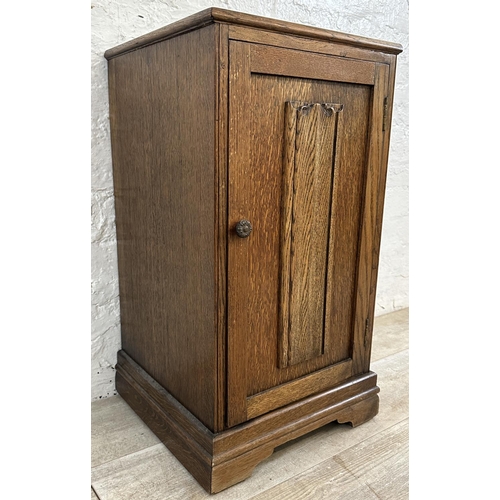 186 - A mid 20th century carved oak linenfold bedside cabinet - approx. 67cm high x 39cm wide x 35cm deep