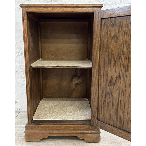 186 - A mid 20th century carved oak linenfold bedside cabinet - approx. 67cm high x 39cm wide x 35cm deep