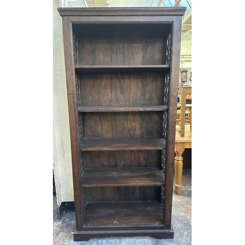 193 - An Indian sheesham wood and wrought metal five tier bookcase - approx. 182cm high x 86cm wide x 37cm... 