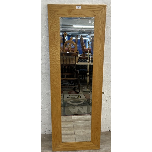 194 - A modern oak framed bevelled edge wall mirror - approx. 140cm high x 48cm wide