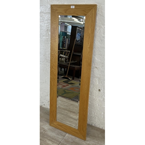 194 - A modern oak framed bevelled edge wall mirror - approx. 140cm high x 48cm wide