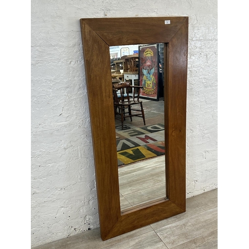 28 - A modern mango wood framed wall mirror - approx. 70cm high x 145cm wide