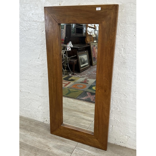 28 - A modern mango wood framed wall mirror - approx. 70cm high x 145cm wide