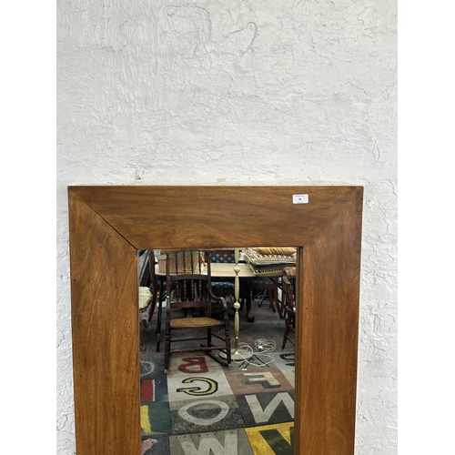 28 - A modern mango wood framed wall mirror - approx. 70cm high x 145cm wide