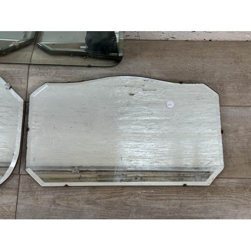 31 - Three mid 20th century Art Deco style frameless bevelled edge wall hanging mirrors - largest approx.... 