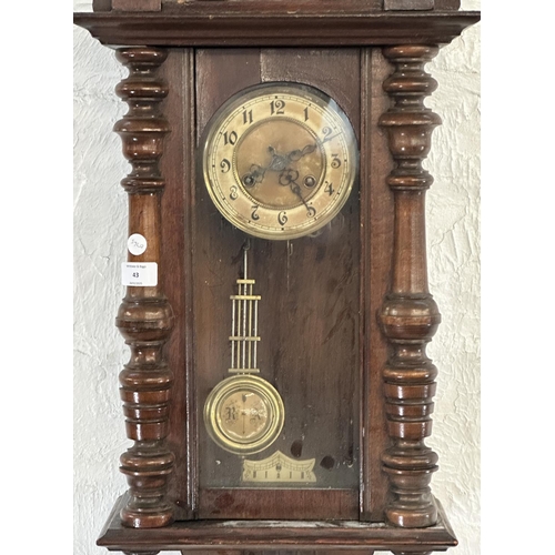 43 - A late 19th/early 20th century walnut cased chiming wall clock with pendulum and key - approx. 85cm ... 