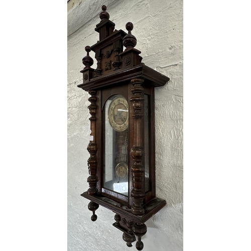 43 - A late 19th/early 20th century walnut cased chiming wall clock with pendulum and key - approx. 85cm ... 