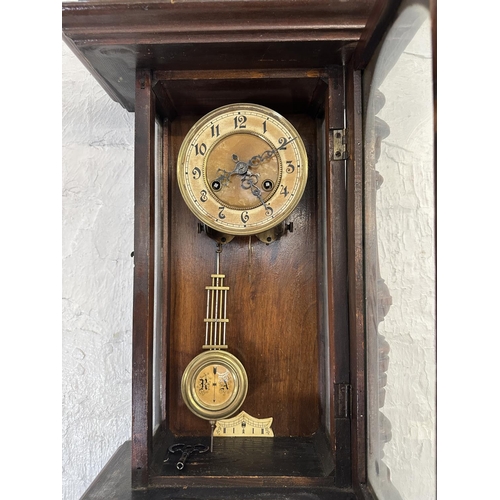 43 - A late 19th/early 20th century walnut cased chiming wall clock with pendulum and key - approx. 85cm ... 