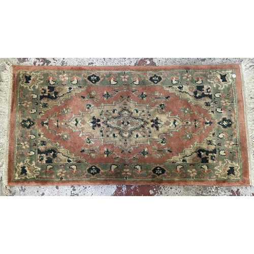 46 - Three rugs, two Oushak style pink ground - approx. 130cm x 62cm and one Chinese pink floral - approx... 