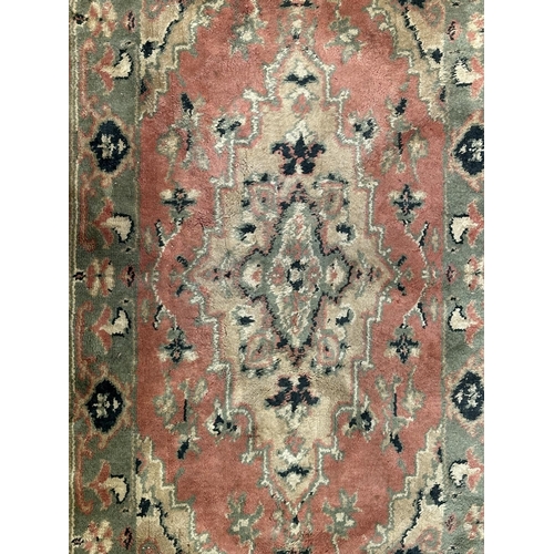 46 - Three rugs, two Oushak style pink ground - approx. 130cm x 62cm and one Chinese pink floral - approx... 