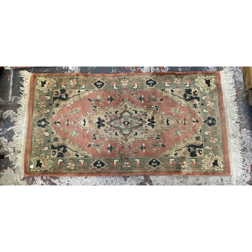 46 - Three rugs, two Oushak style pink ground - approx. 130cm x 62cm and one Chinese pink floral - approx... 