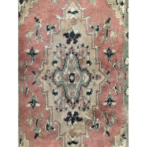 46 - Three rugs, two Oushak style pink ground - approx. 130cm x 62cm and one Chinese pink floral - approx... 